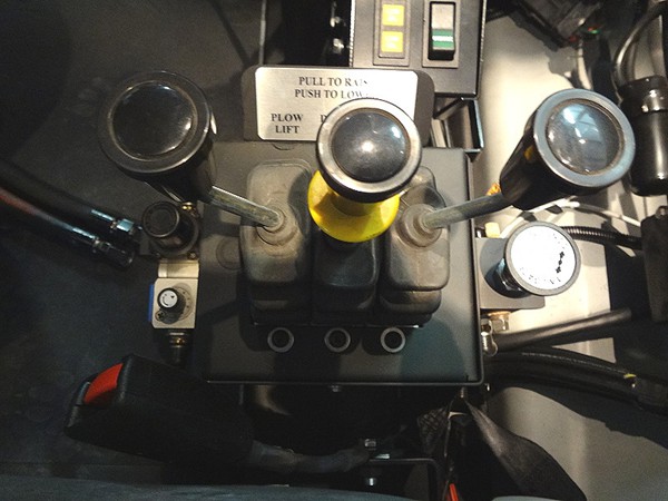DEL valves with lit knobs and a function decal in a plow truck console